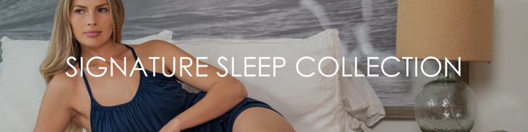 Woman laying on bed in navy Slumber Party Top and navy Siesta Sista Short